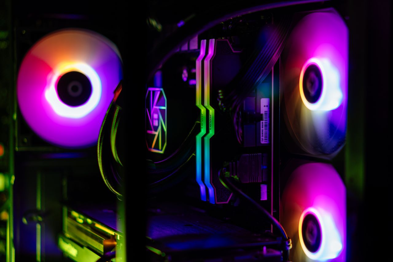 Close-up of a custom-built RGB gaming PC showcasing vibrant lighting and high-performance components.